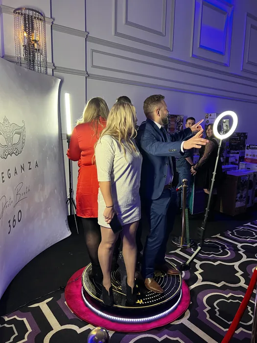Three guests recording a video together on the 360 booth platform