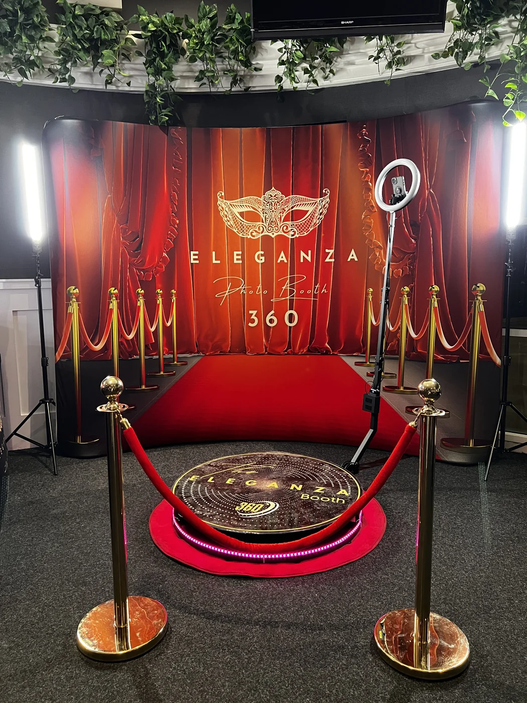 The Eleganza 360 booth set up with red carpet and curtain backdrop at a Miami event