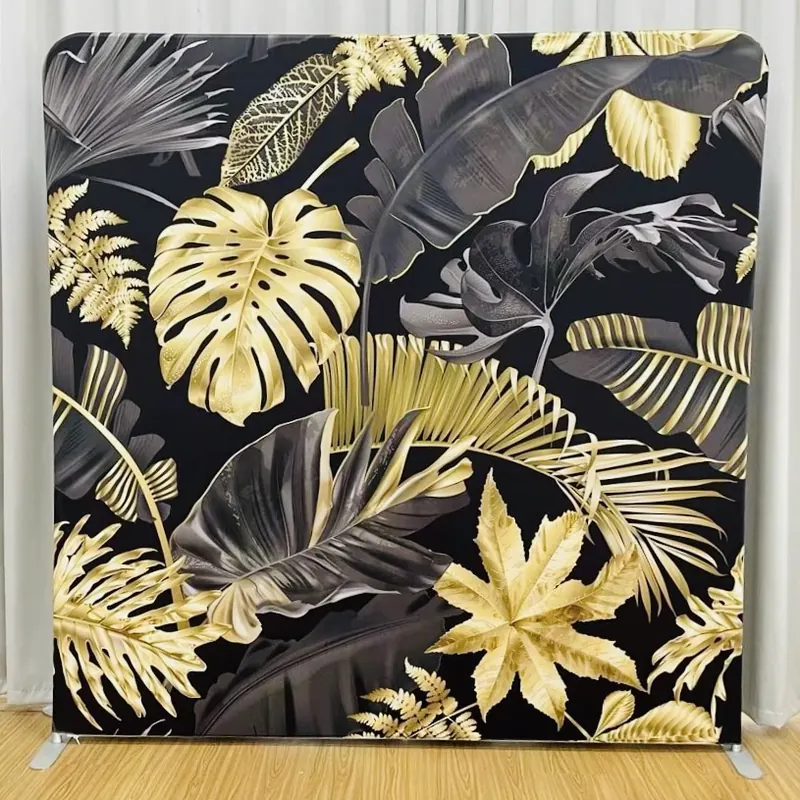 Black and gold tropical photo booth backdrop at a Miami event
