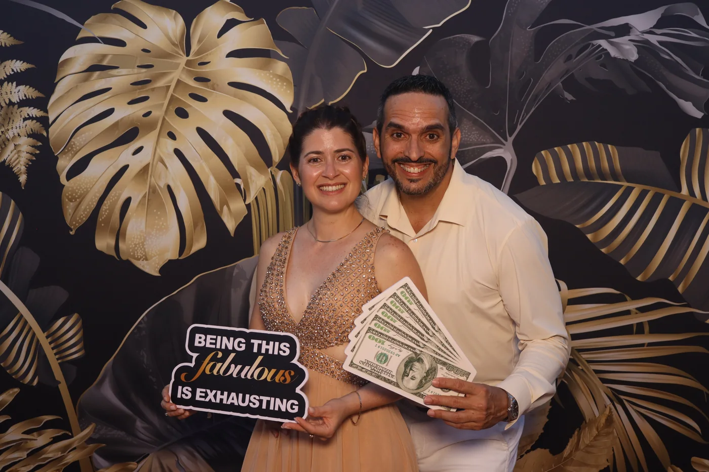 Guests holding a prop sign at the photo booth during a 40th birthday in Miami