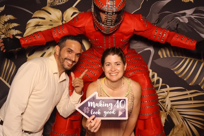 Friends taking a fun digital photo booth picture at a birthday party
