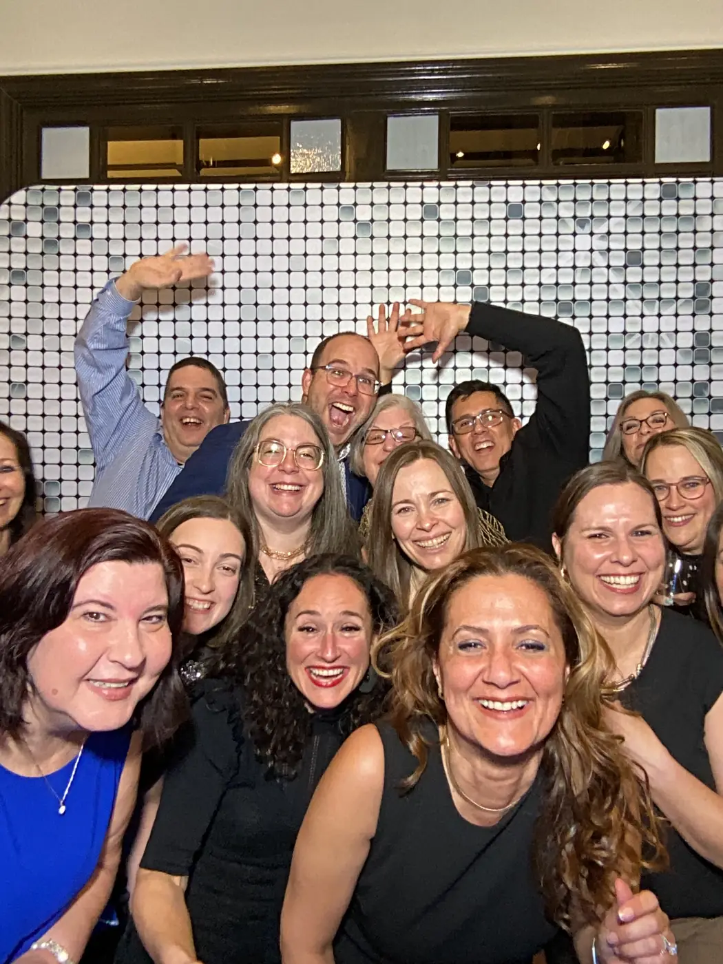 A large team crowded into the photo booth at a Miami corporate event