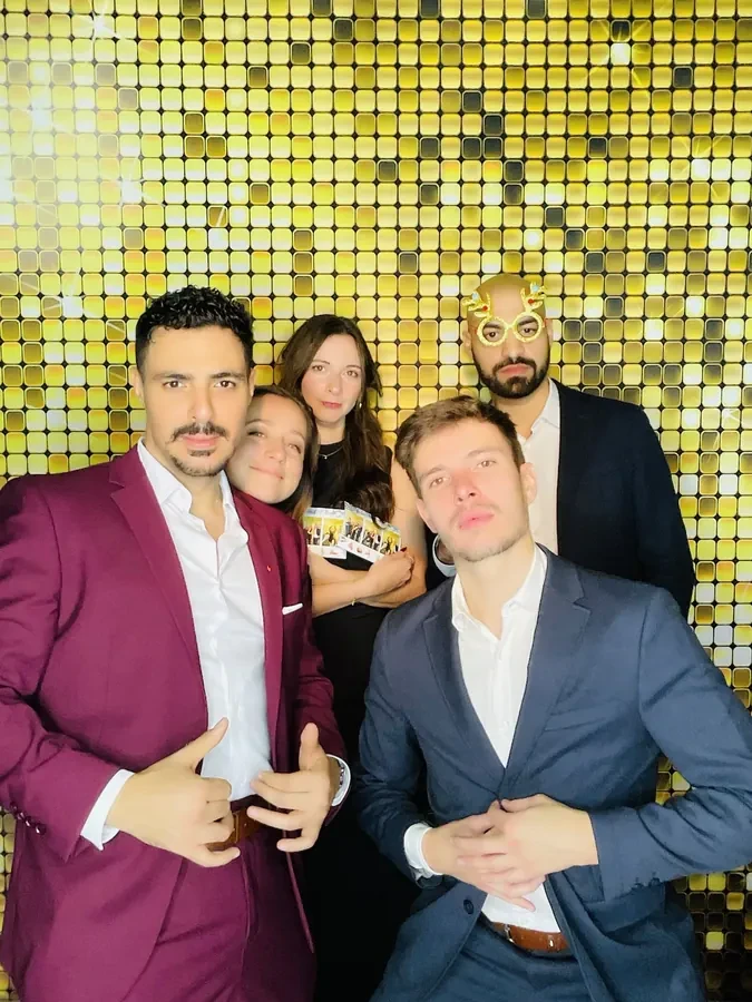 Guests holding branded signs at a corporate photo booth in Miami