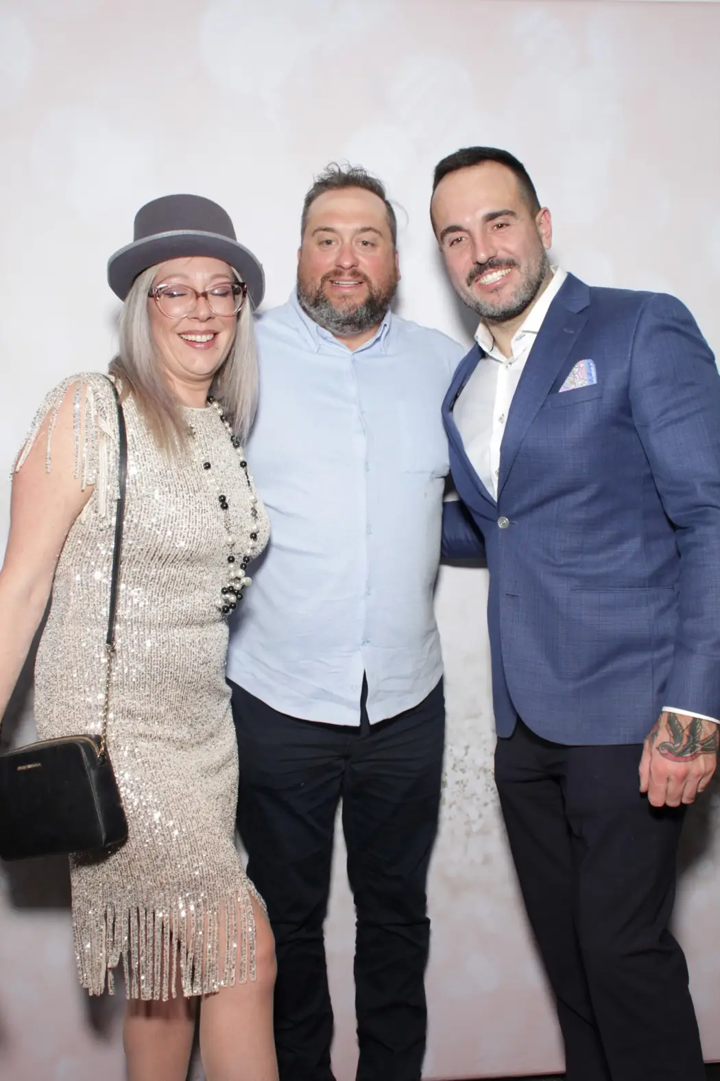 Colleagues in formalwear at the photo booth during a Miami corporate gala