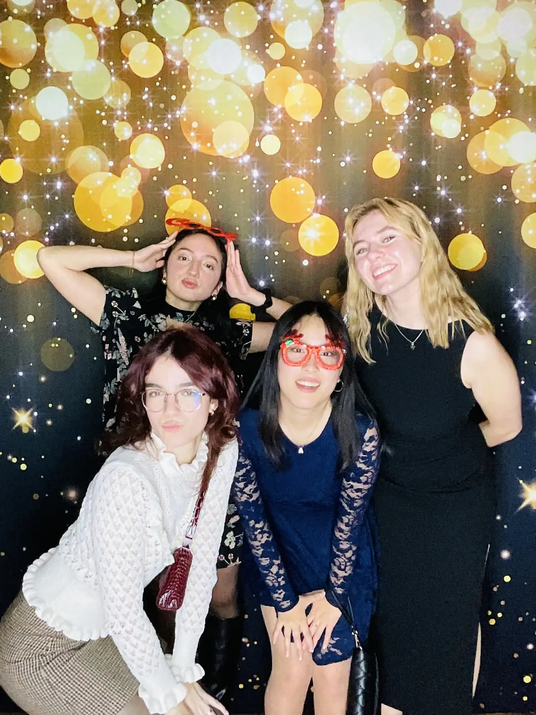 Colleagues at the photo booth against a gold bokeh backdrop at a Miami company event
