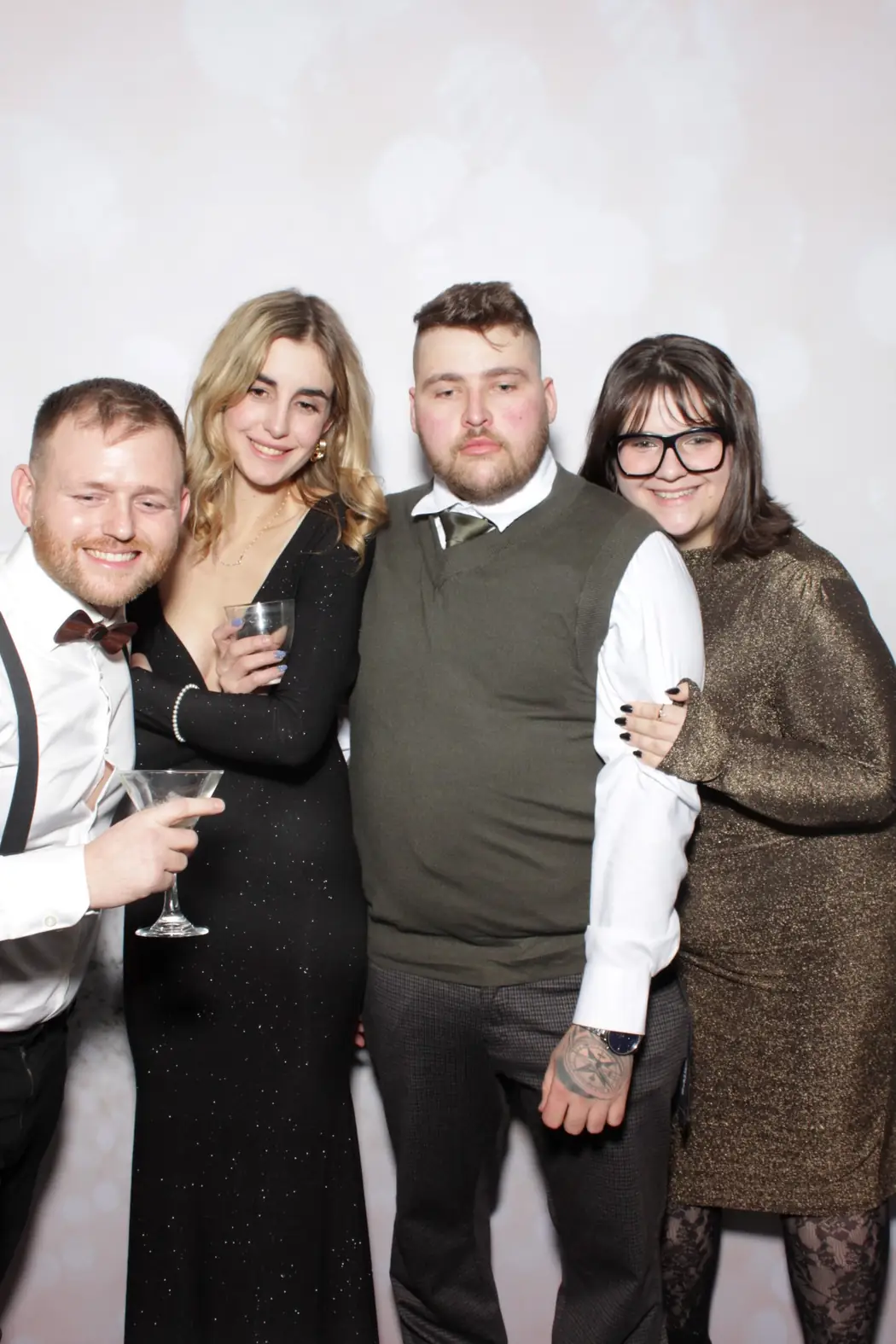 Colleagues with drinks at the photo booth during a Miami company holiday party
