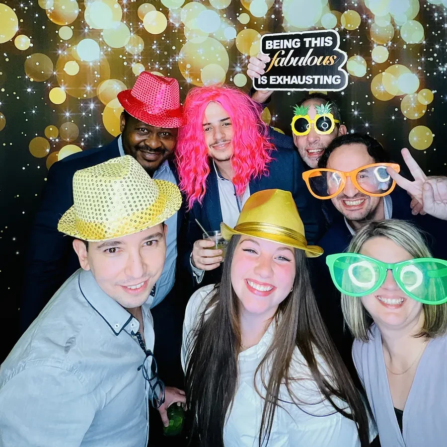 Colleagues at the photo booth during a Miami holiday party