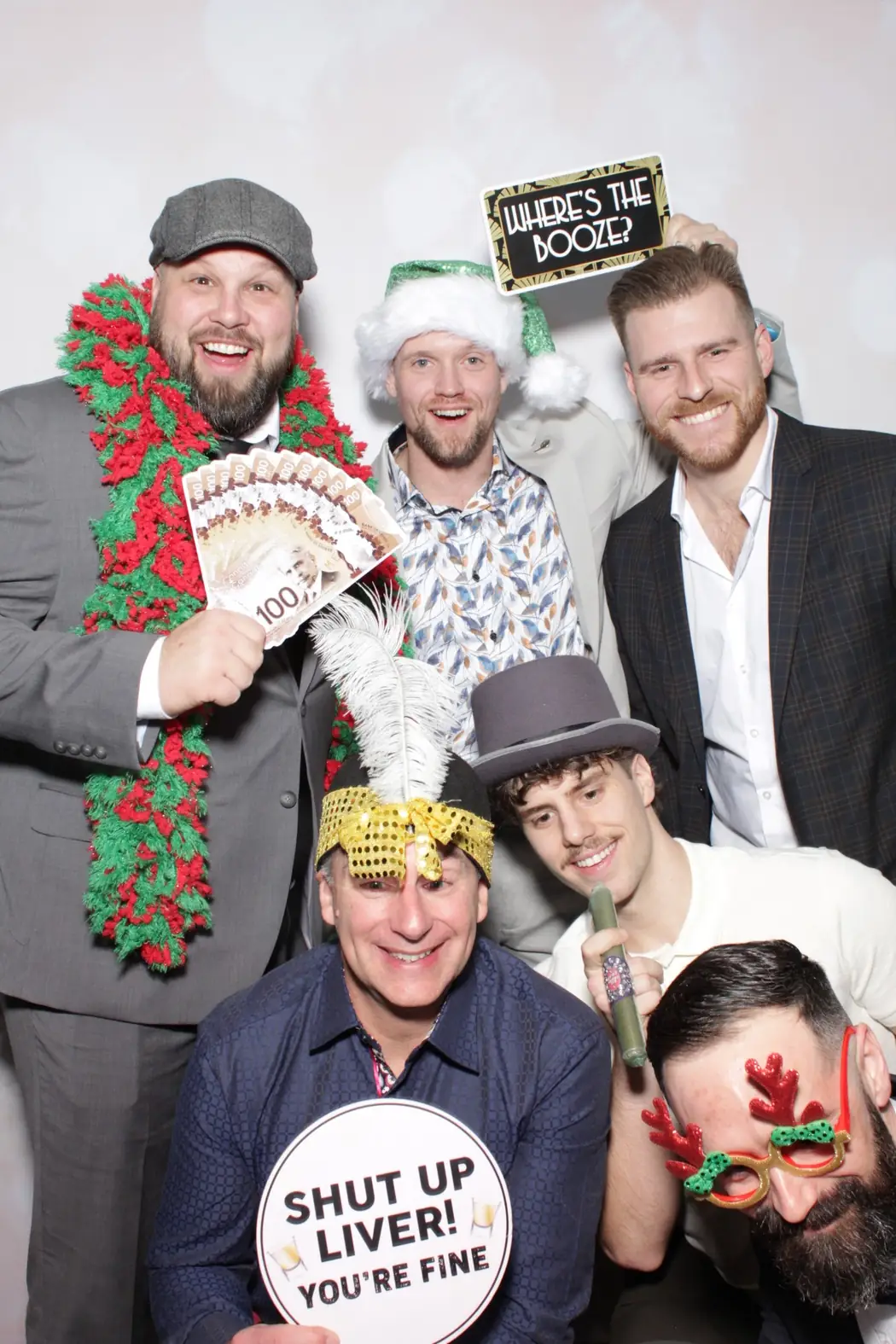 Colleagues with festive props at the photo booth during a Miami company holiday party