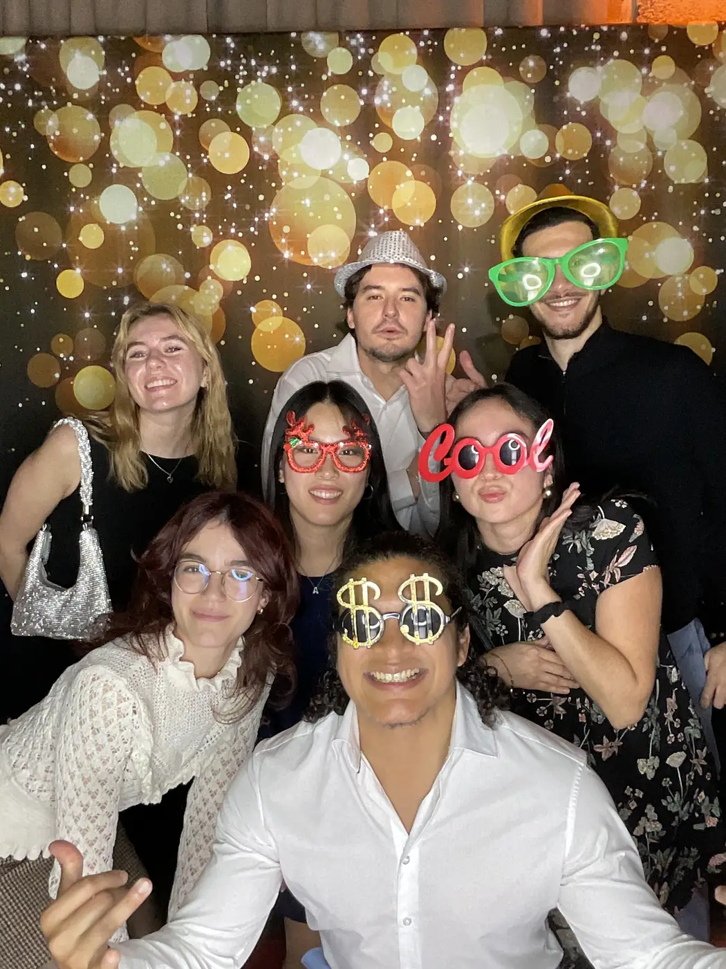 Colleagues in novelty glasses at the photo booth during a Miami company holiday party