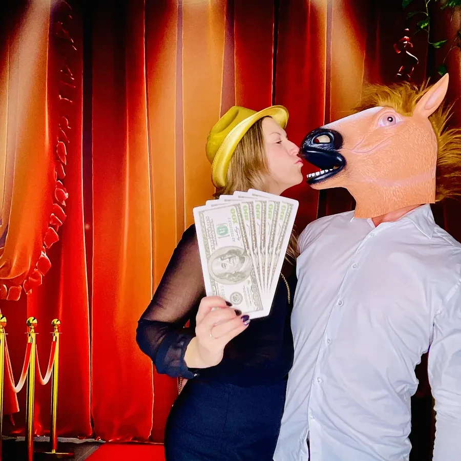 Guests using props at a corporate photo booth in Miami