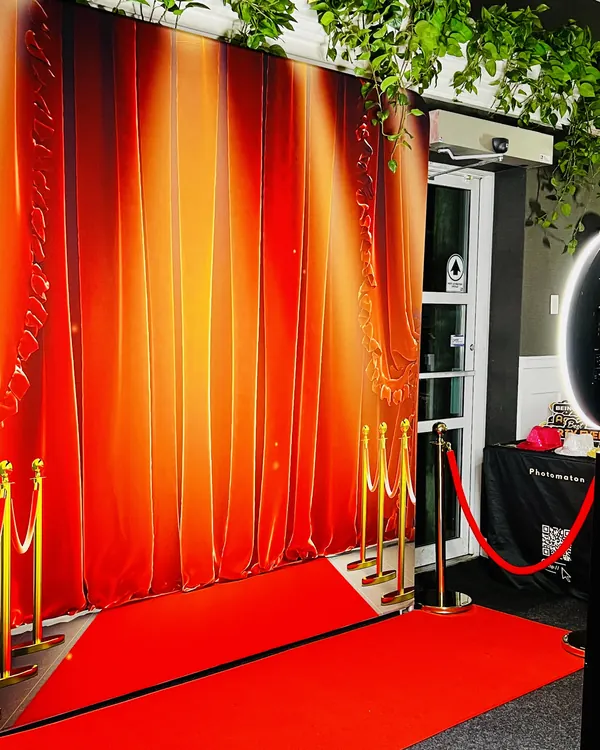 Coworkers posing at a digital photo booth during a company event