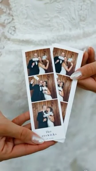 A guest holding two classic photo booth print strips at a Miami wedding, printed and dry within seconds