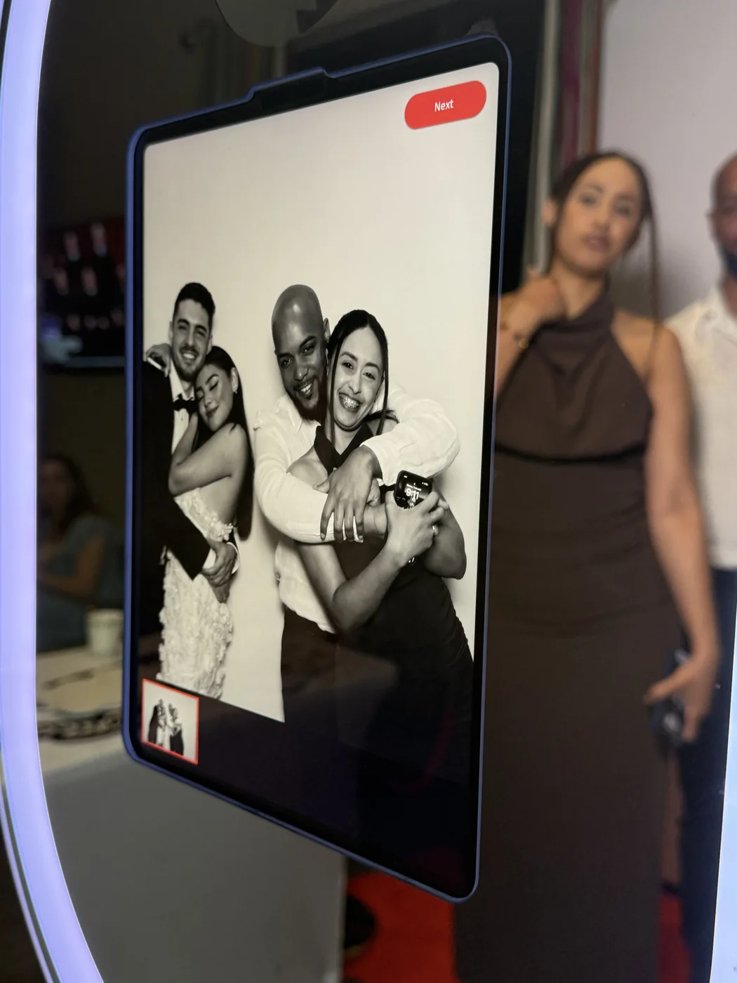 Guests reviewing their black and white glam portrait on the booth screen