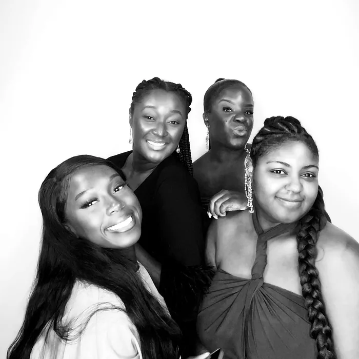 Four friends smiling for a Glam Booth portrait