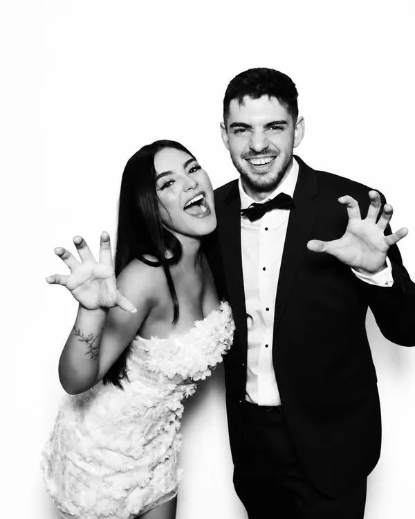 Bride and groom posing for black-and-white Glam Booth portraits in Miami