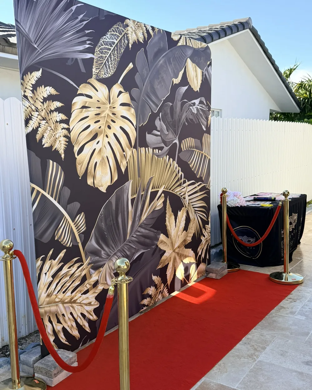 Guests posing in front of a photo booth backdrop in Miami