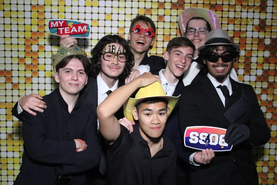 Prom guests using props at the photo booth in Miami
