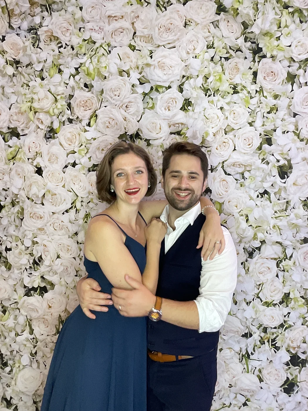 A couple in formal wear at the photo booth at a wedding in Aventura