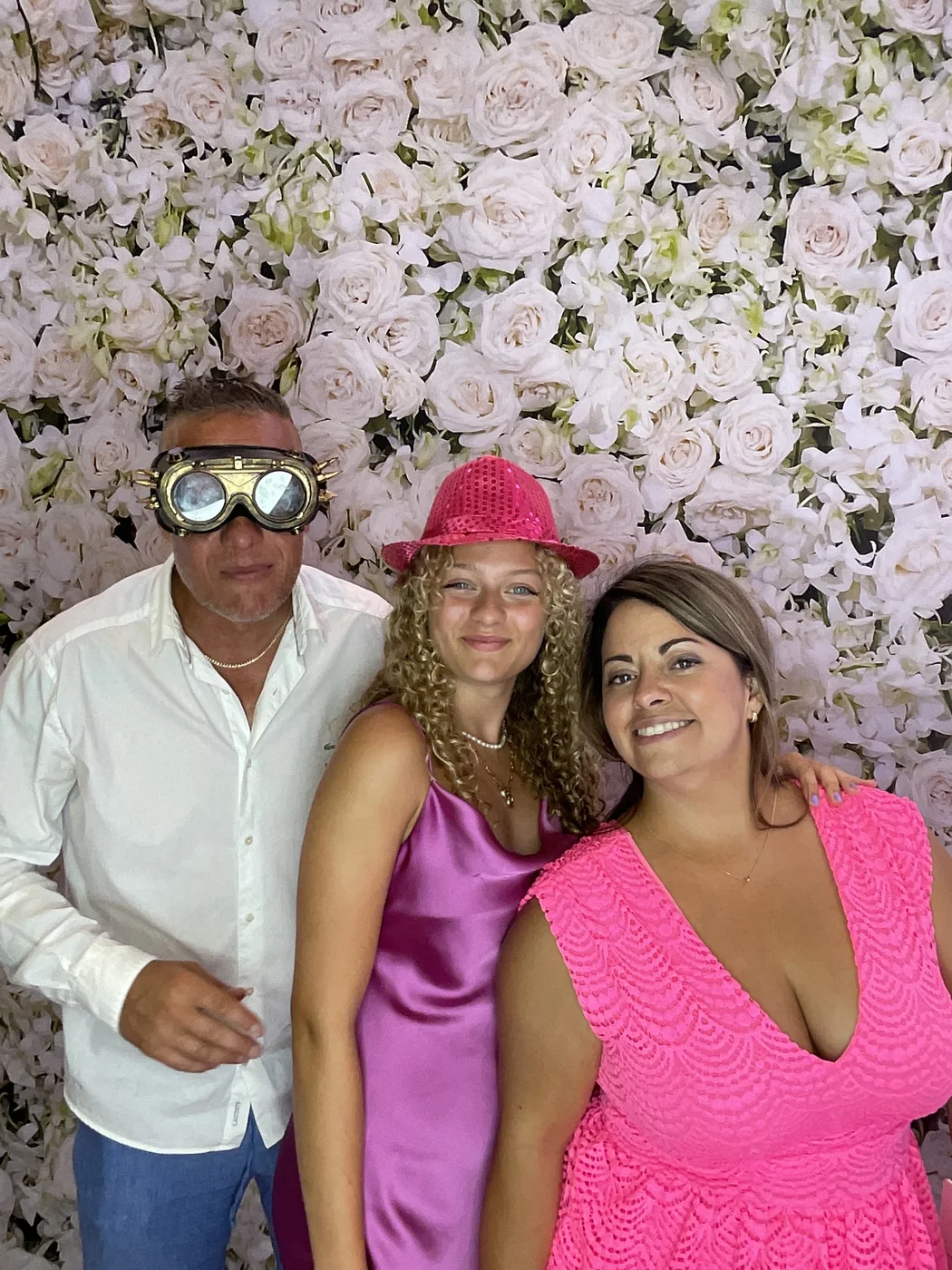 Three guests with props at the photo booth at a wedding in Aventura
