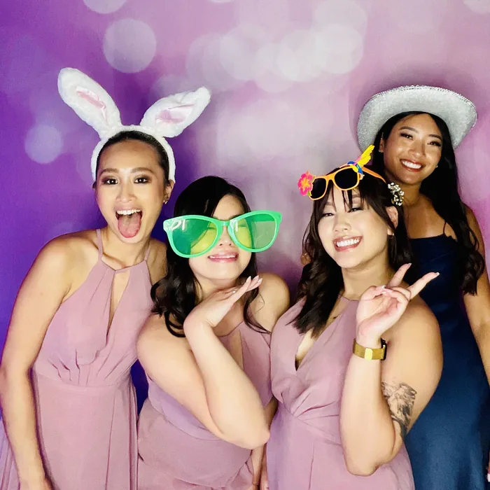 Wedding guests wearing colorful props at a Miami photo booth