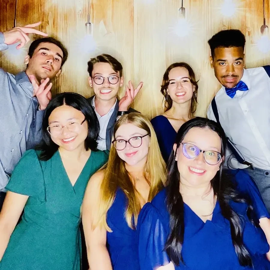 Wedding guests holding signs at the photo booth in Miami