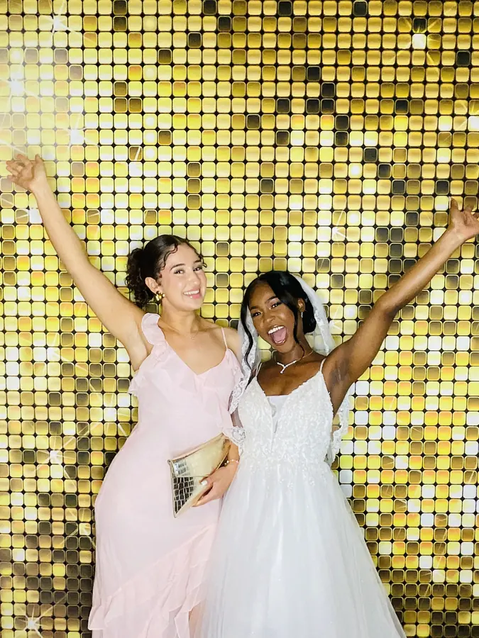 Wedding photo booth set up with a gold backdrop in Coral Gables