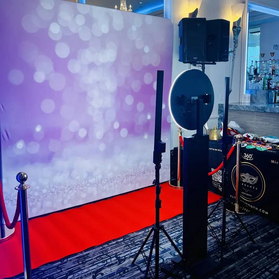 A group at the photo booth against a whitewashed wood backdrop at a Miami wedding